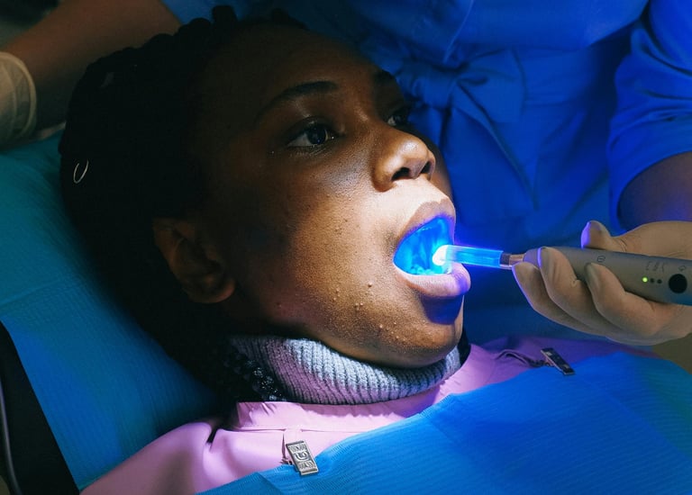 Dentist using a curing light on a filling